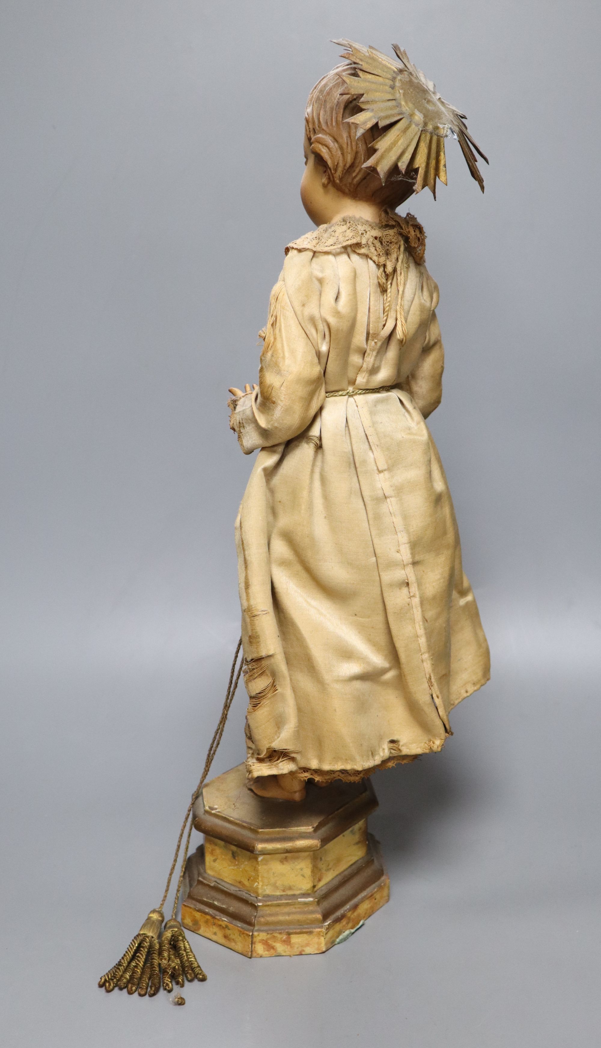 A late 19th century Continental carved and painted wood statue of a Saint, on a plinth base, height 49cm